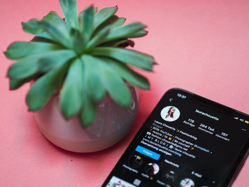 black iphone 4 on pink surface