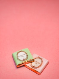 Close-up of delicate artisanal sweets in soft pink and green wrapping, highlighting texture and detail.
