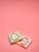 Two small wrapped chocolates lie on a pink surface. The wrapping includes elegant branding with the text 'Laduree Paris' and decorative golden embellishments. One wrapper is pastel green, and the other is a light pink.