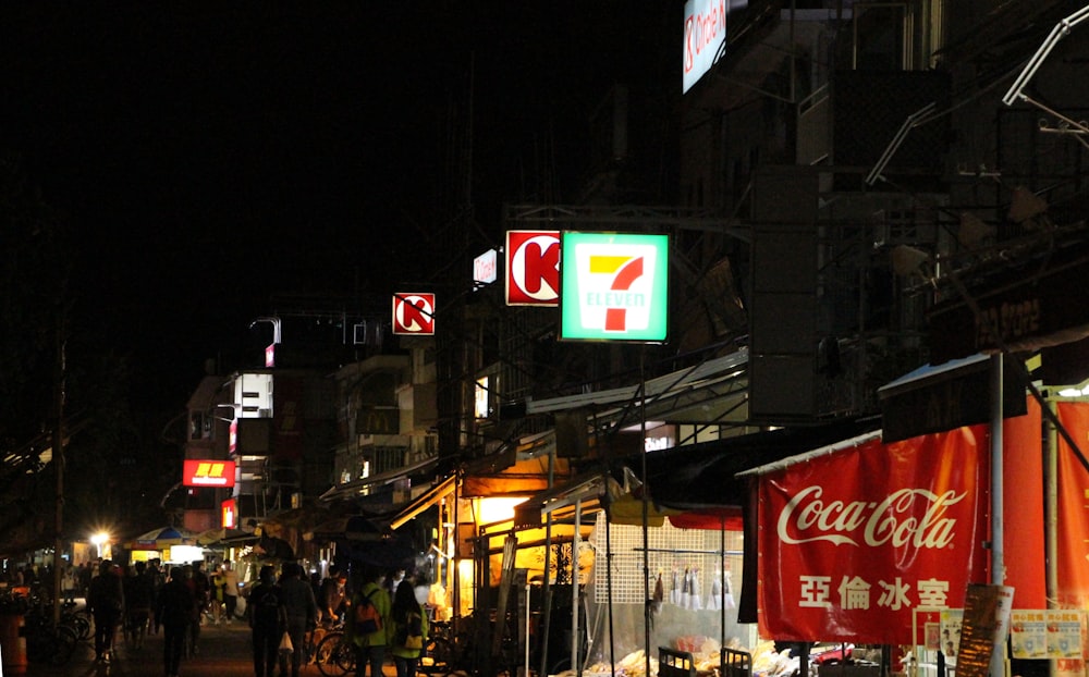 people walking on street during night time