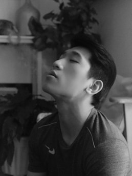 A peaceful setting featuring a person practicing face yoga with soft lighting and plants.