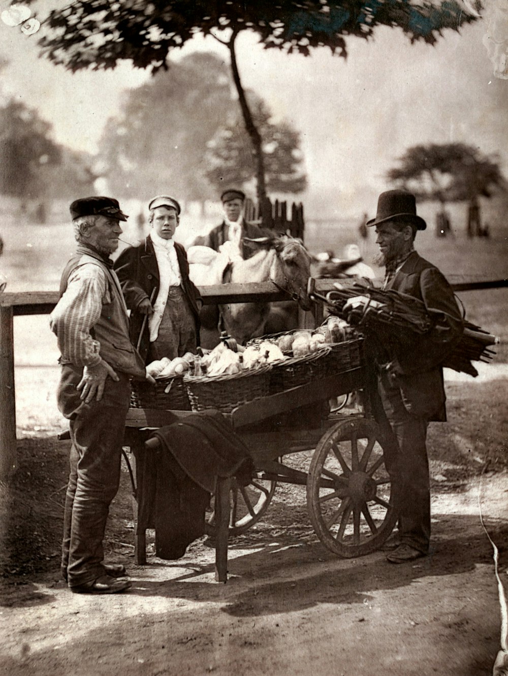 grayscale photo of man and woman in front of fruit stand