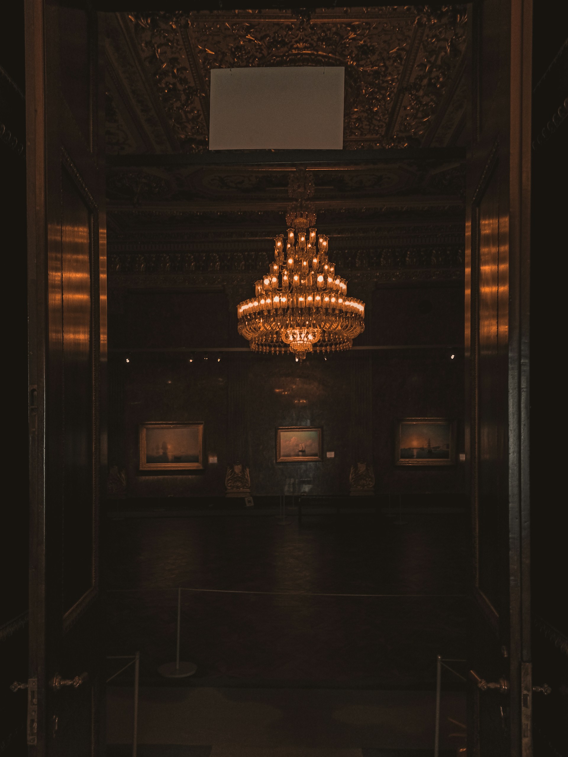 gold chandelier on brown wooden ceiling