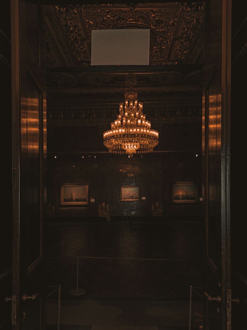 gold chandelier on brown wooden ceiling