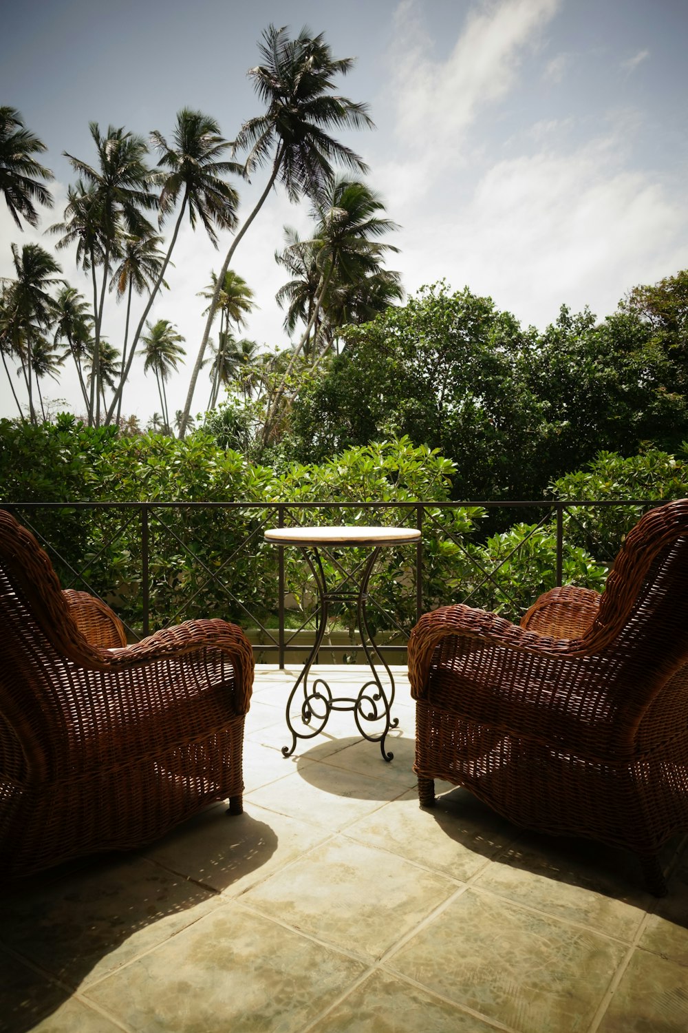 brown wicker armchair beside brown wooden table