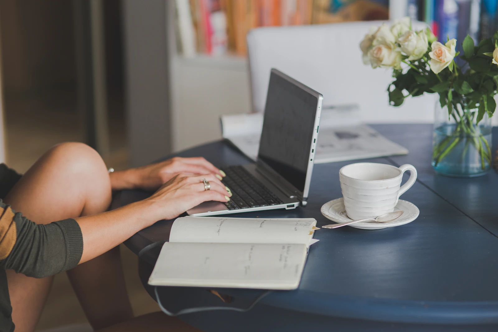 A freelancer at a wooden desk reviewing financial paperwork next to a laptop — the kind of self-employment recordkeeping the new 1099-K rules demand