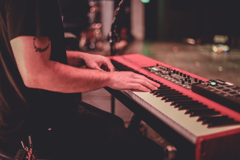 person playing piano in grayscale photography