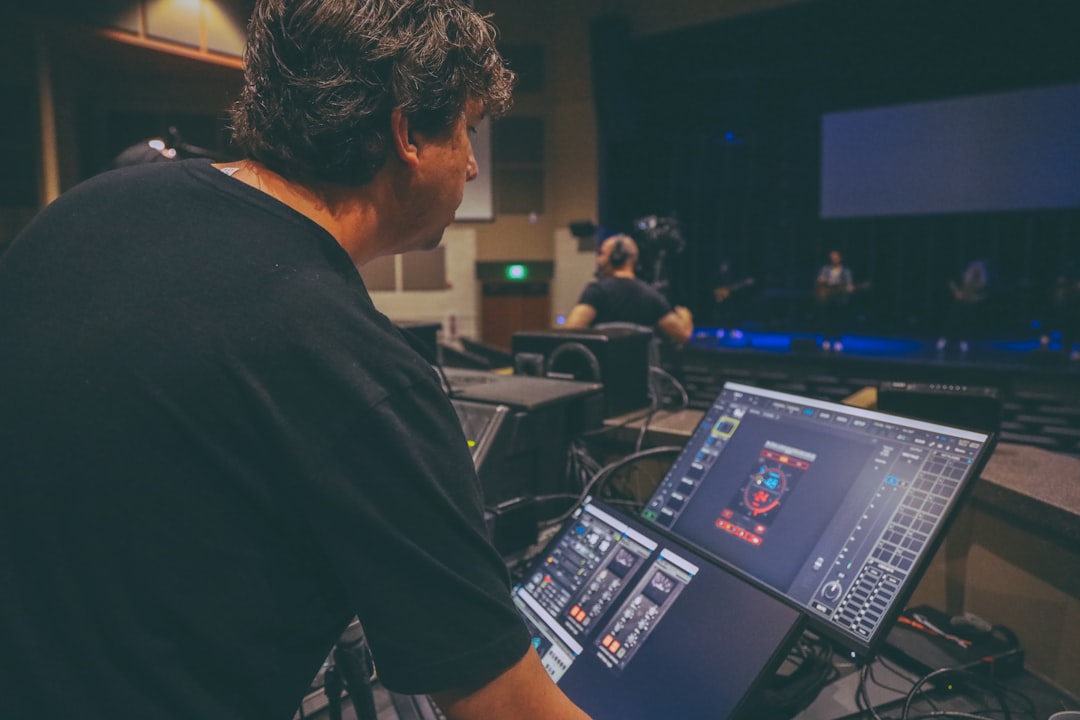 man in black t-shirt using black laptop computer