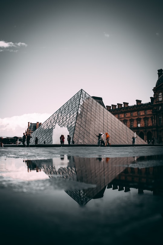 people walking on dock near building during daytime in Louvre France