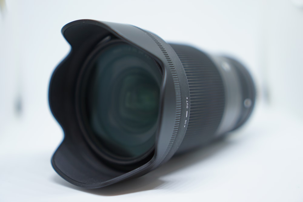 black camera lens on white surface