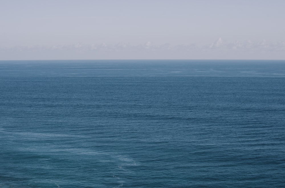 blue ocean water under blue sky during daytime