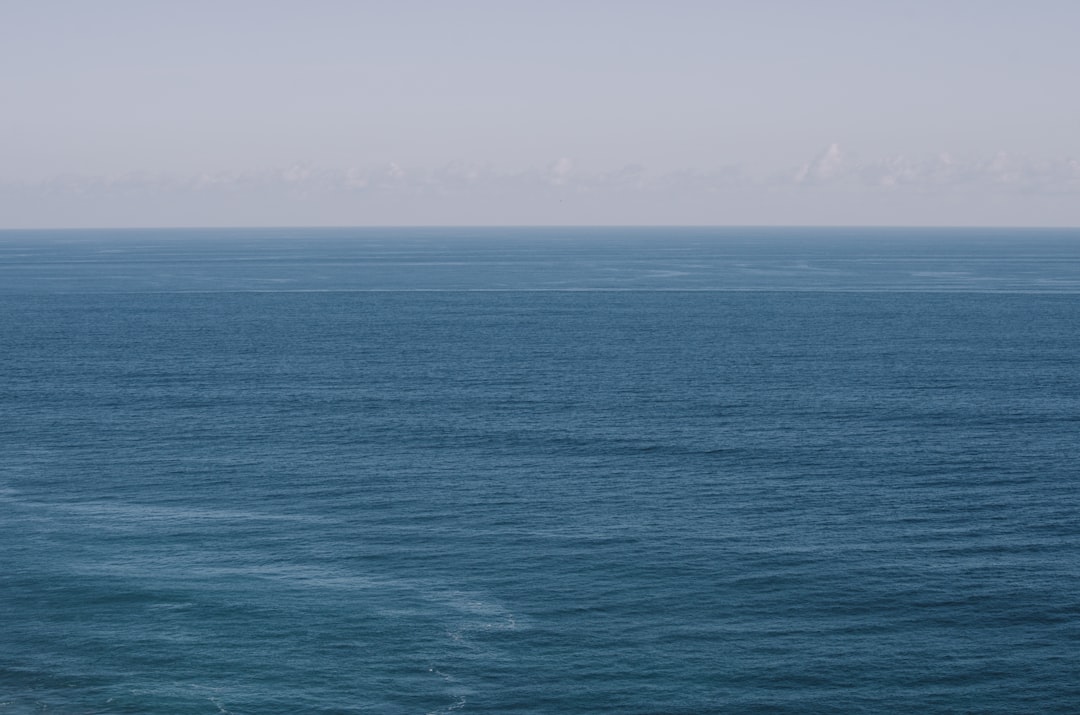 blue ocean water under blue sky during daytime