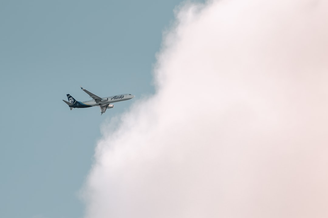 white and blue airplane flying in the sky, Plane-spotting a few arriving flights in to SeaTac