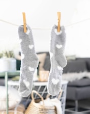 white and gray socks on brown wooden clothes hanger