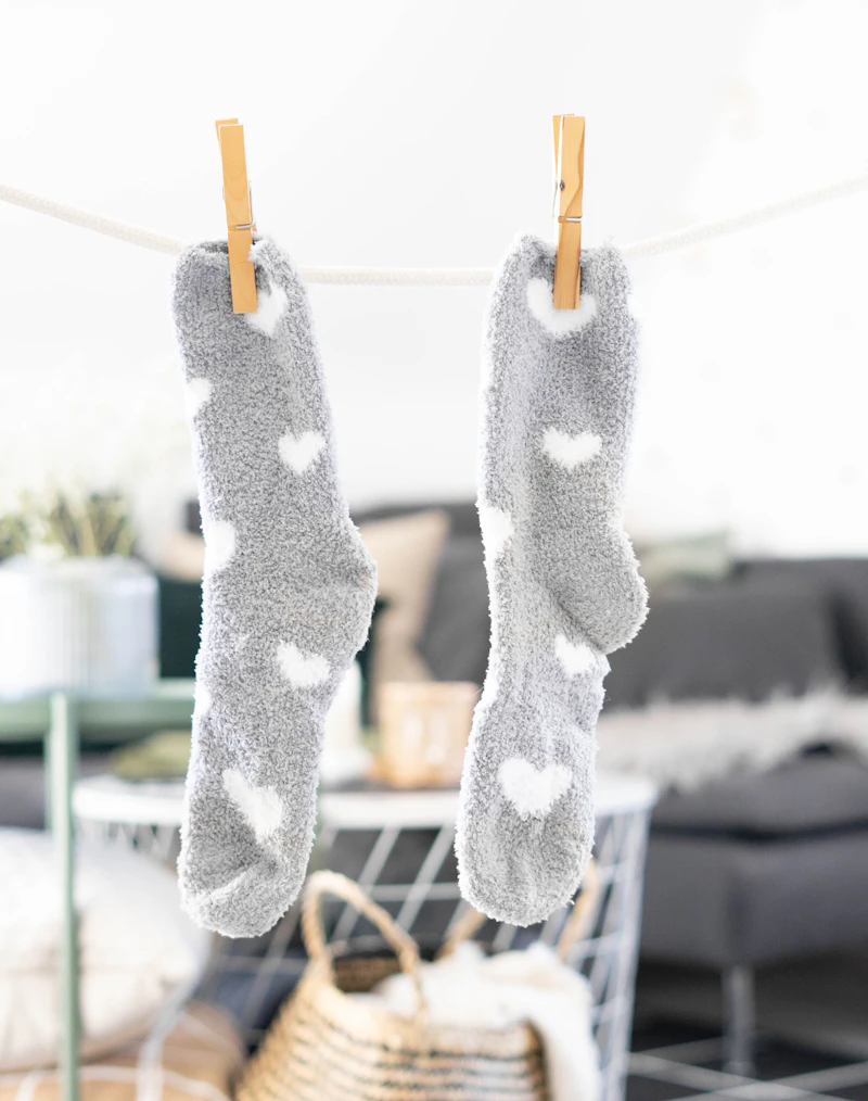 white and grey socks pegged on a clothes line to dry