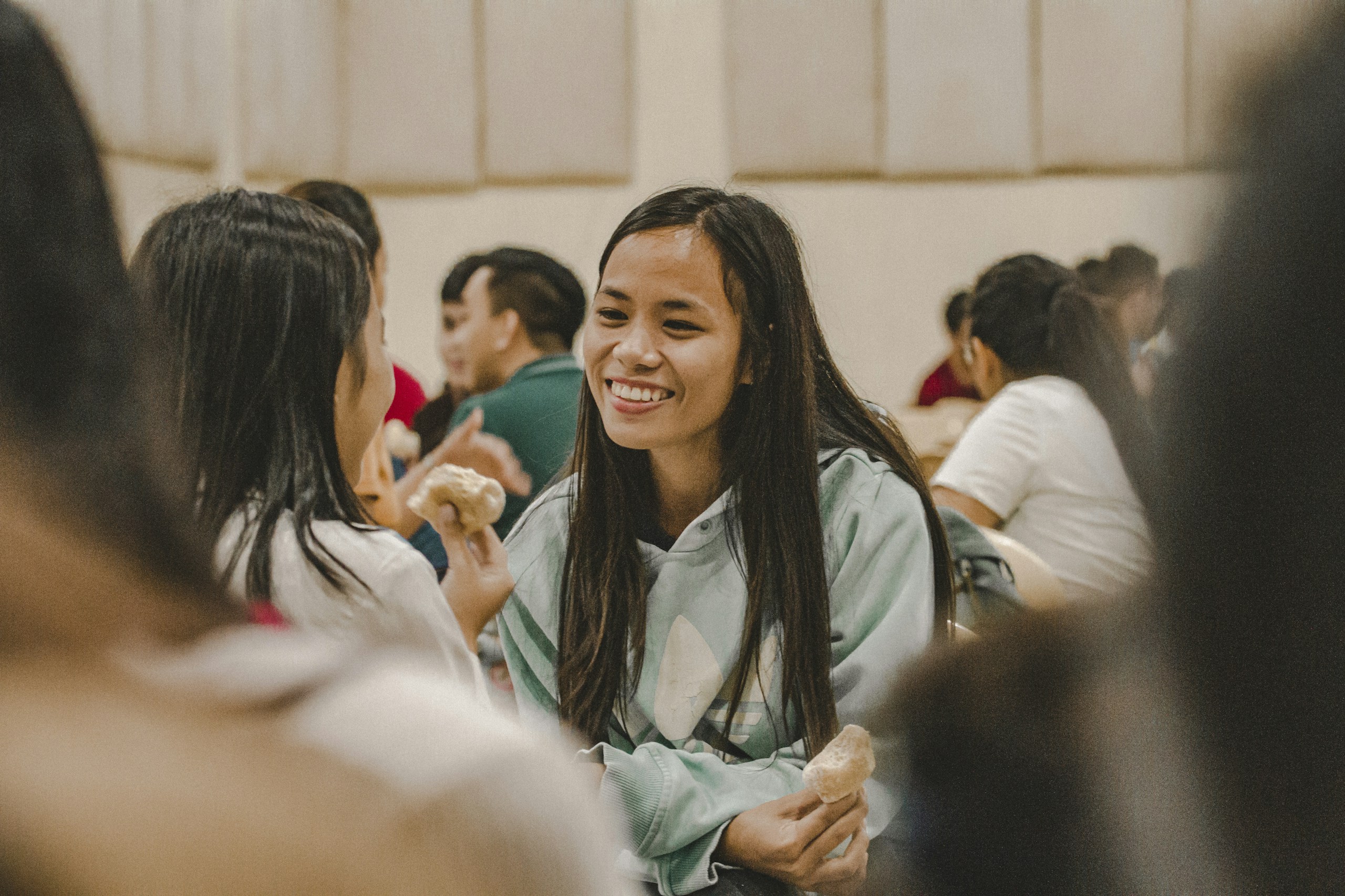 woman in white long sleeve shirt smiling