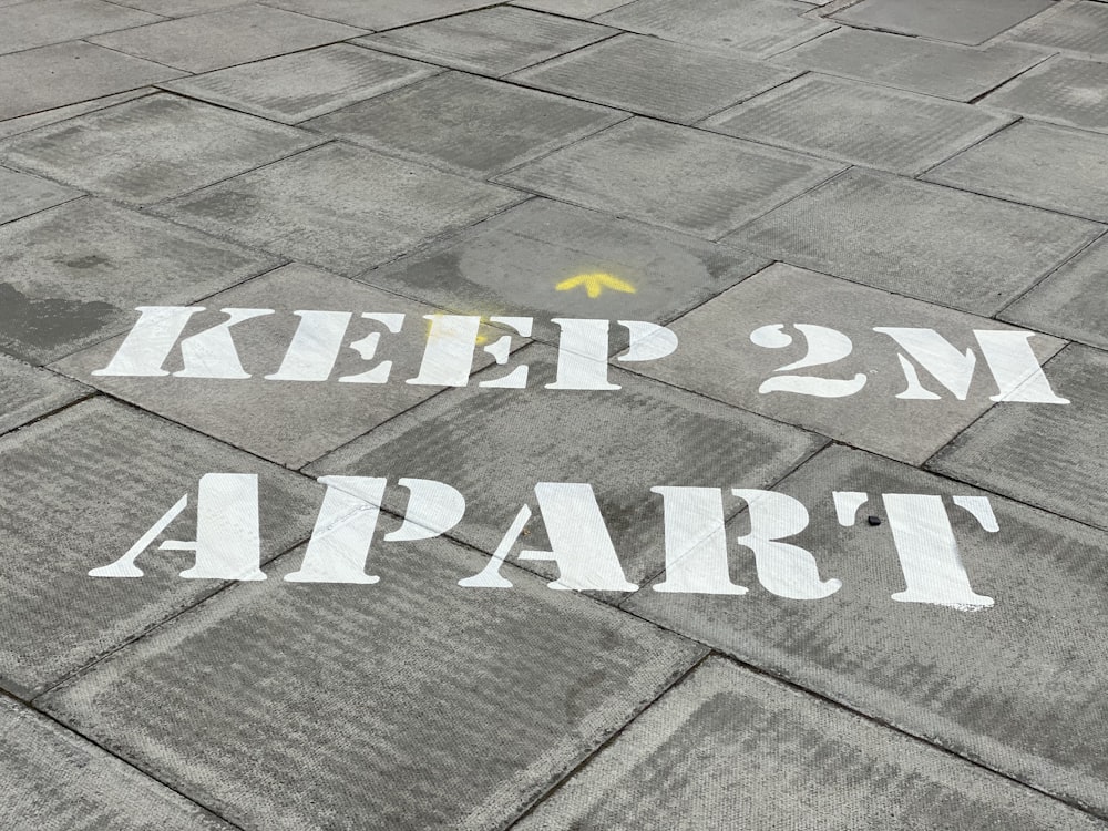 white and black love print on gray concrete pavement