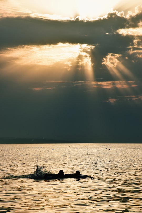 silhouette of people on boat on sea during sunset in Makarska Croatia