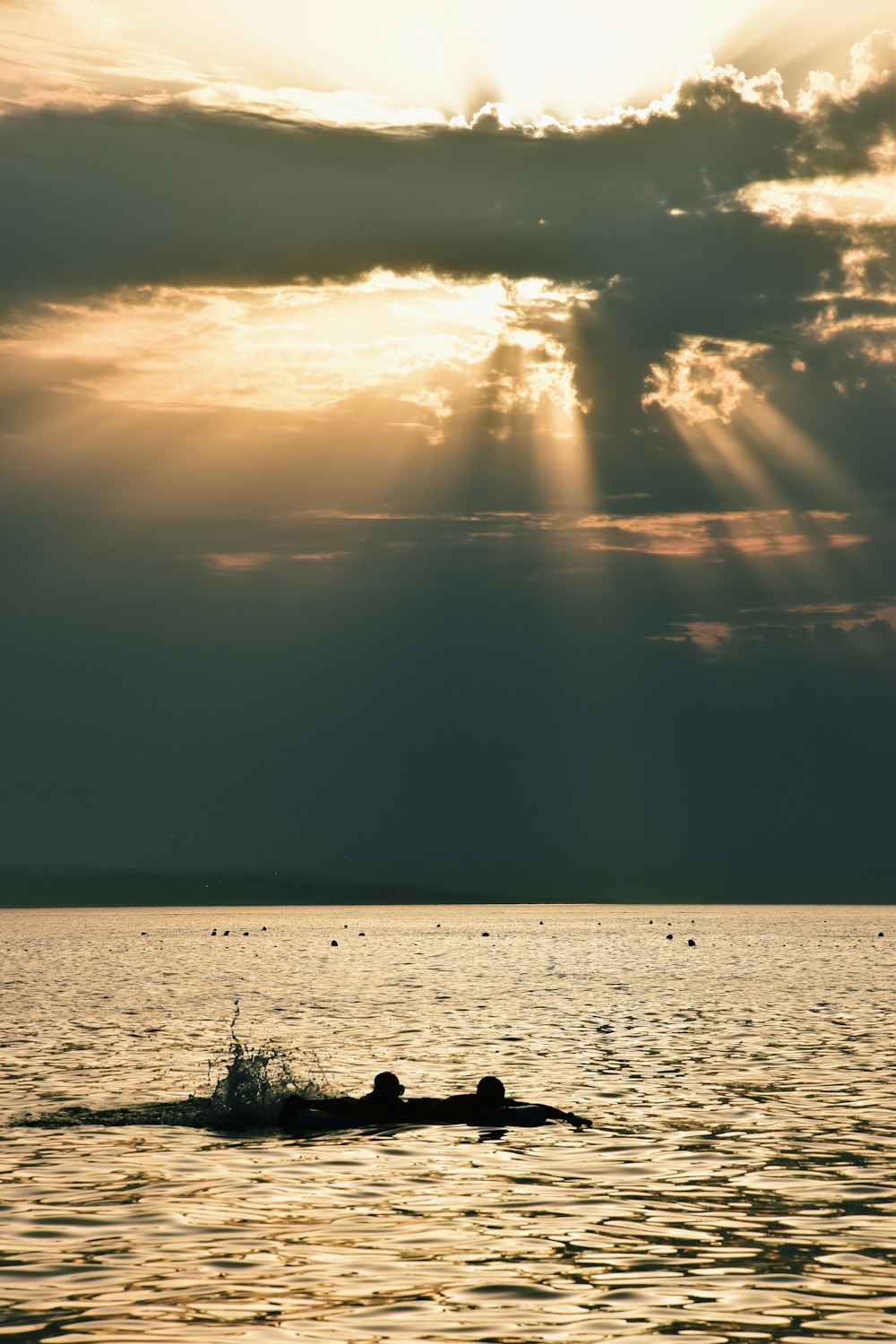silhouette of people on boat on sea during sunset