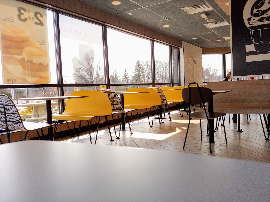 black and yellow chairs and table on white floor tiles