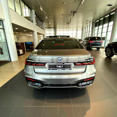 BMW 750li gleaming under soft studio lighting with brushed silver accents.