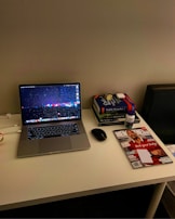 A calm and organized workspace with medical books and a computer screen showing liver anatomy.