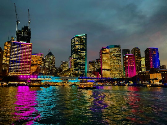 city skyline across body of water during night time in Sydney Cove Australia