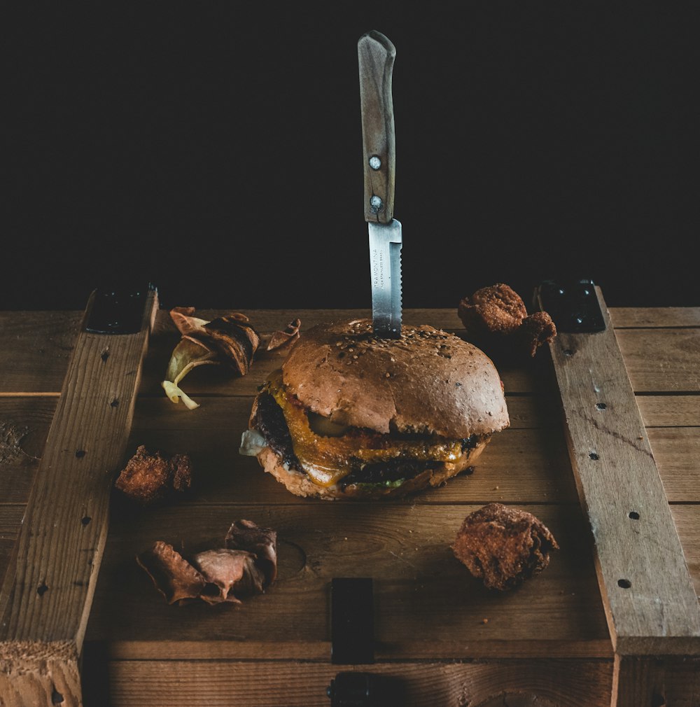 burger on brown wooden chopping board