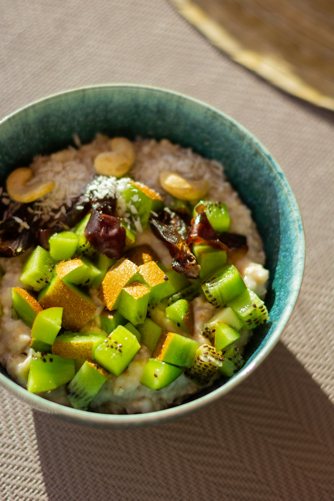 A warm bowl of overnight oats topped with berries and seeds.