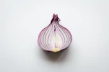 Macro shot of an onion slice with visible layers, hinting at why it makes us cry.