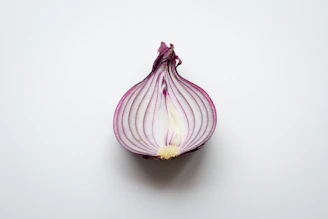 pink and white garlic on white surface