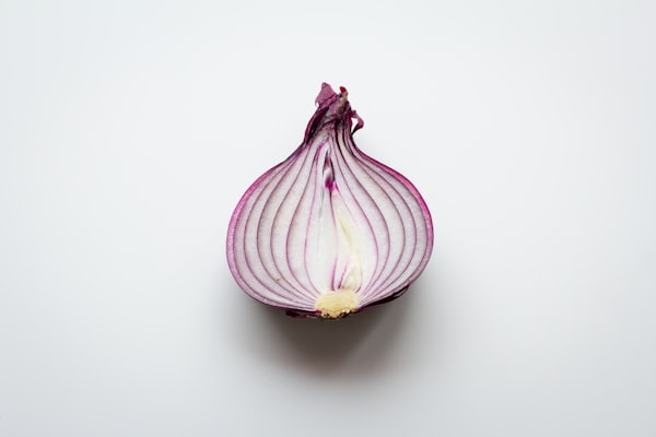 Half of a red onion on a white background