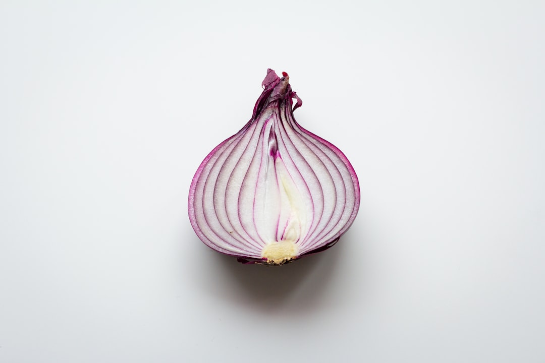 pink and white garlic on white surface