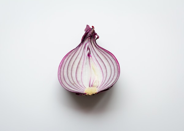 pink and white garlic on white surface