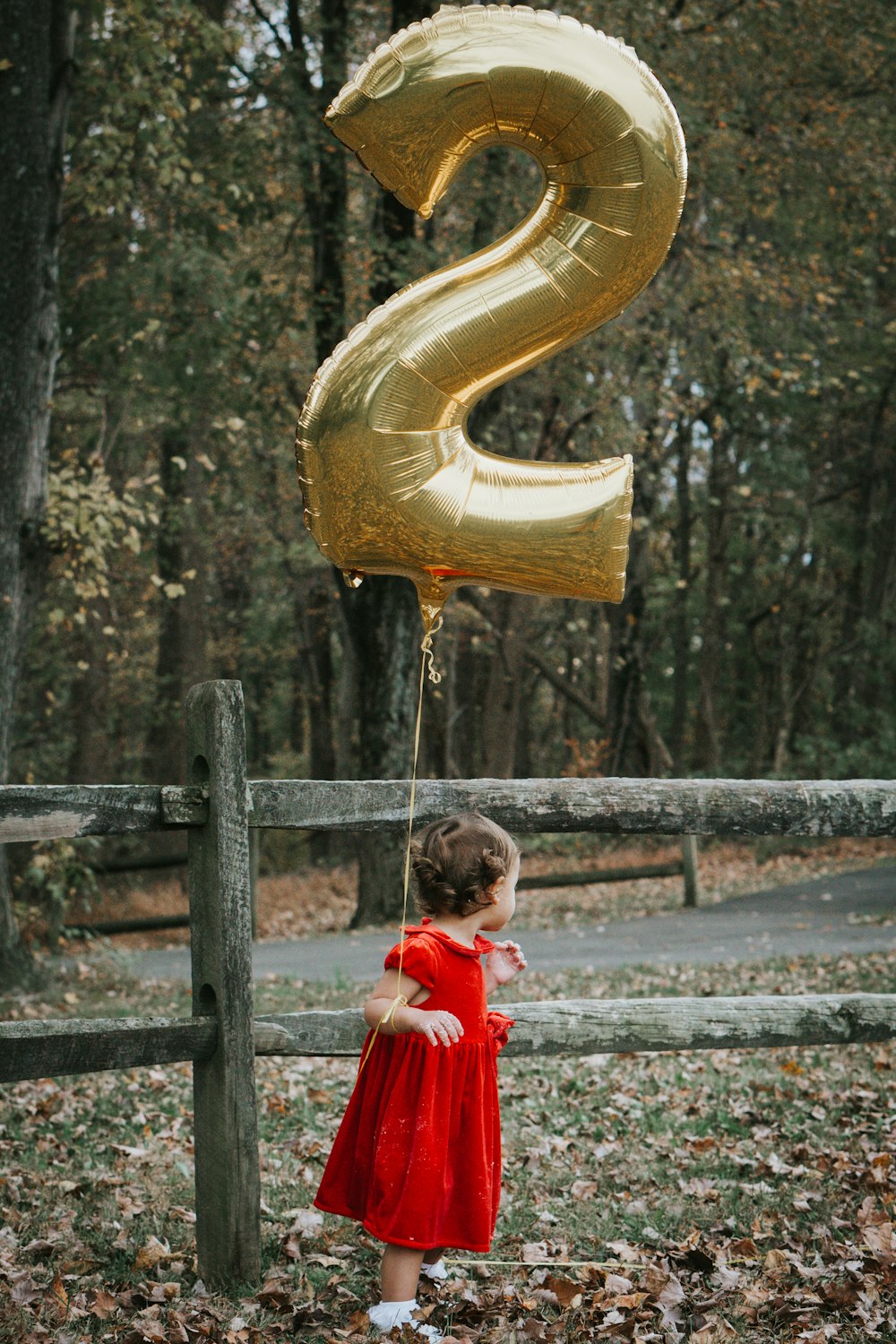 girl in red dress holding yellow inflatable ring