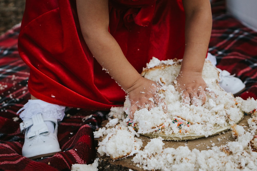 person in red shirt holding white powder