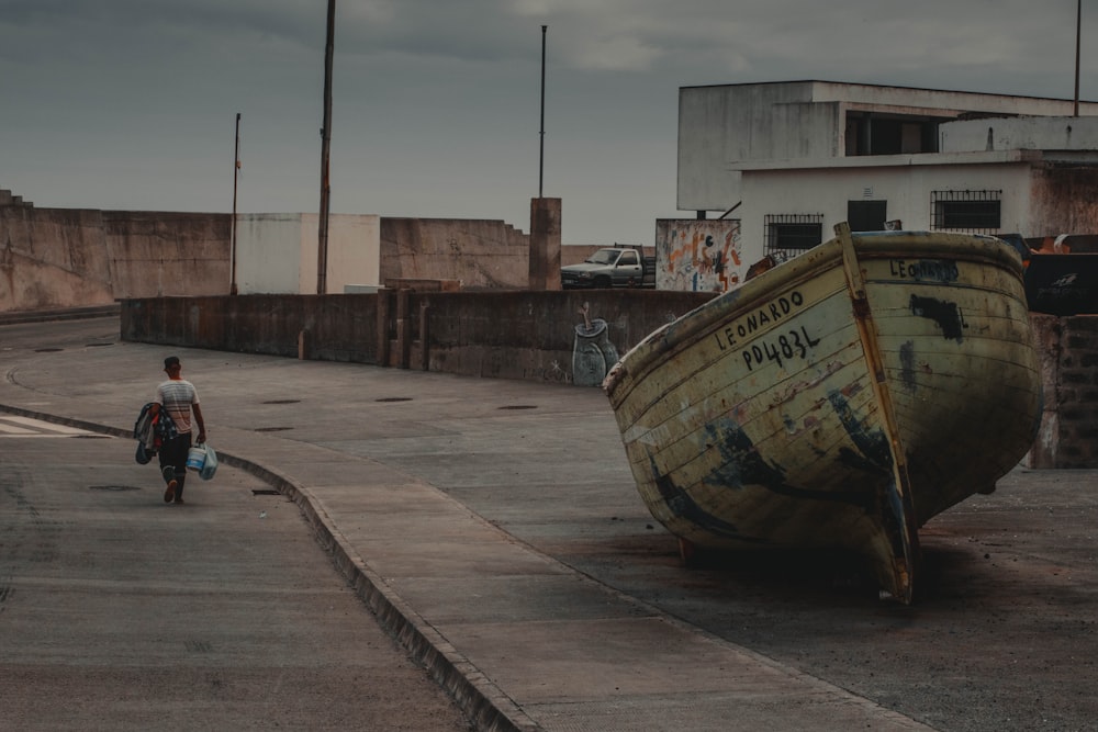 brown wooden boat on gray concrete pavement during daytime