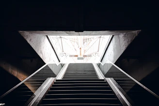 A minimalist architectural staircase bathed in soft natural light, symbolizing steady personal ascent.
