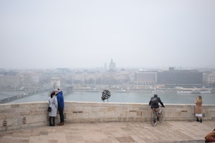 A romantic couple enjoying a scenic city tour with historic buildings in the background.