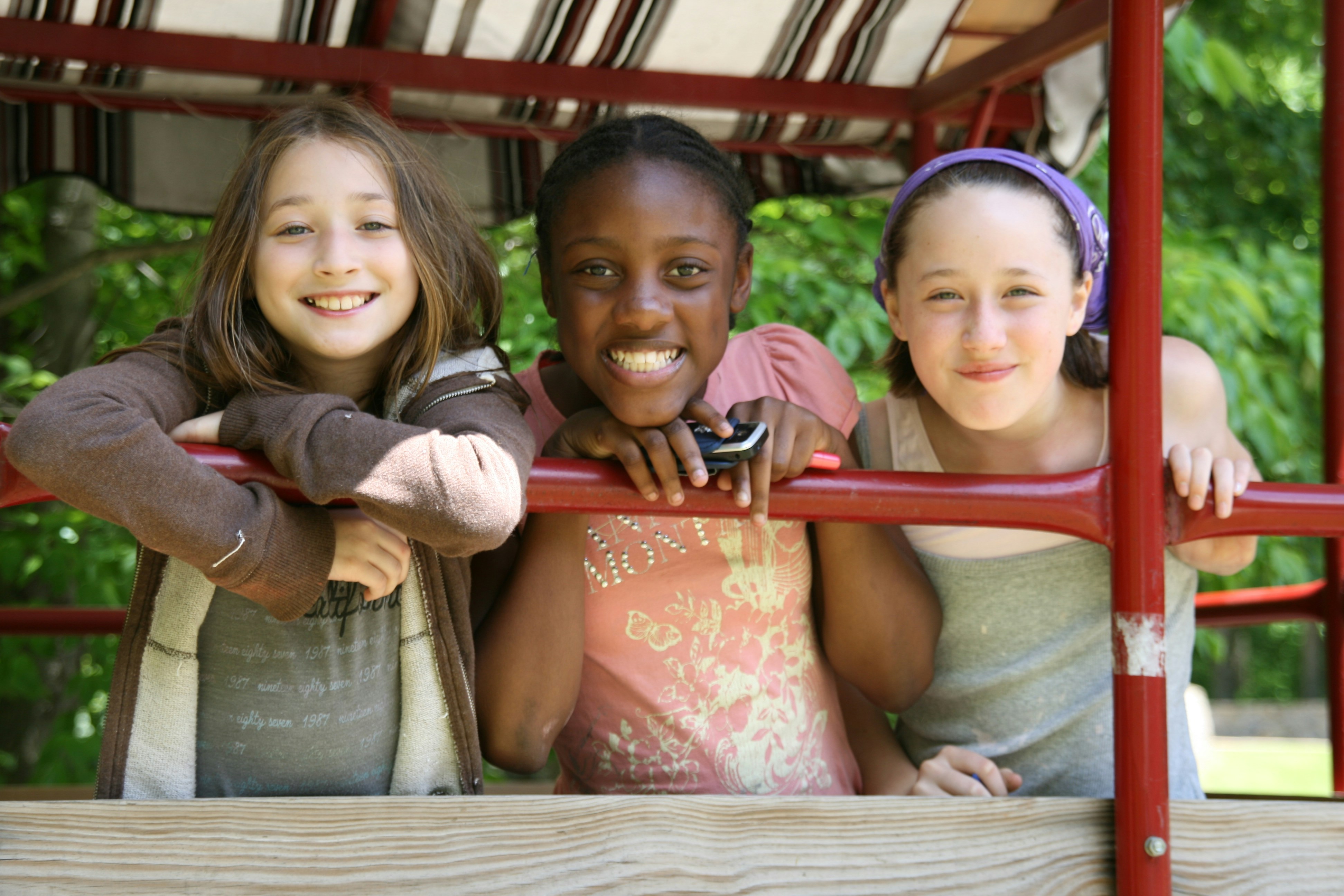 Smiling girls on hay wagon