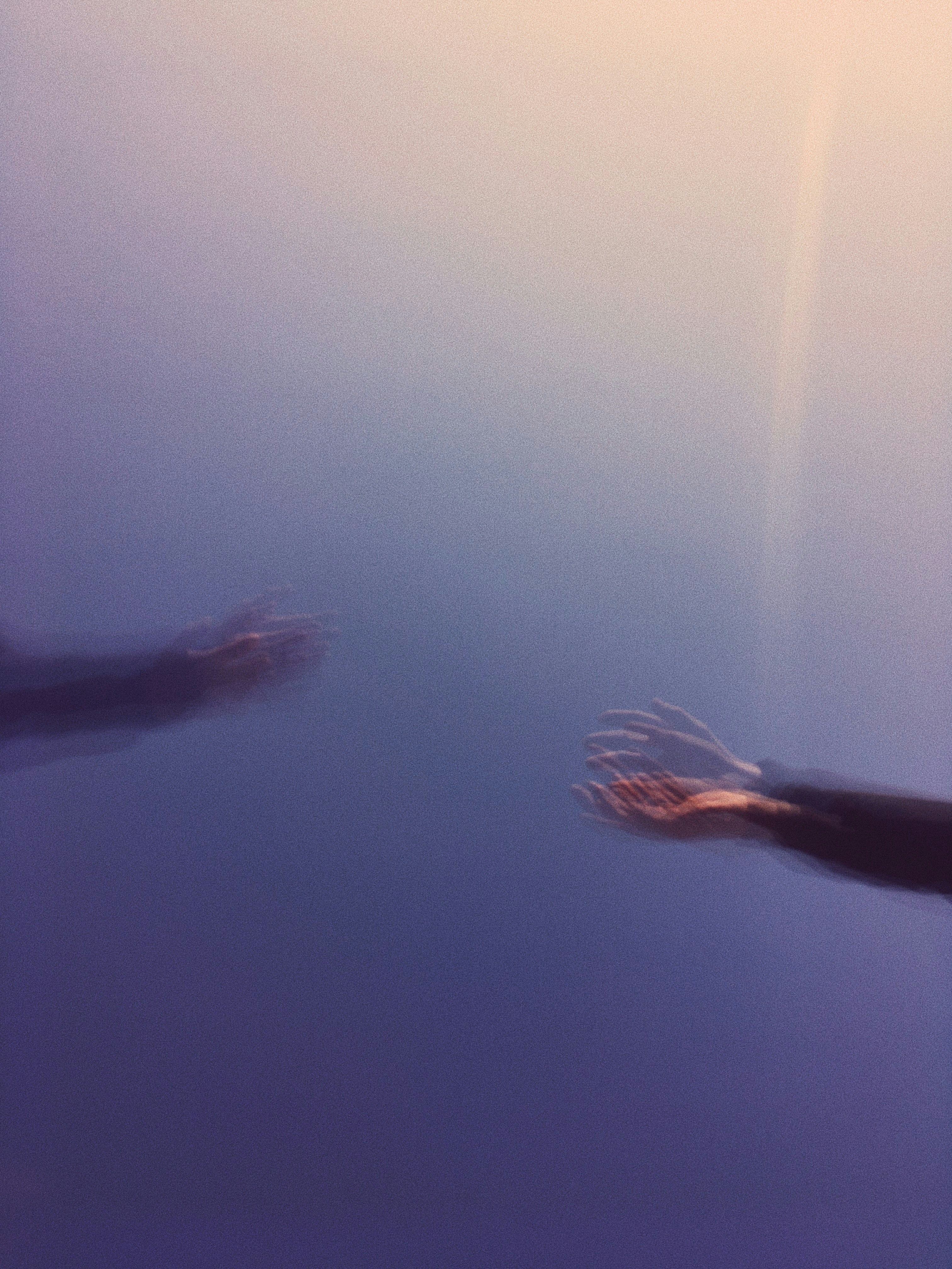 person in black pants under water