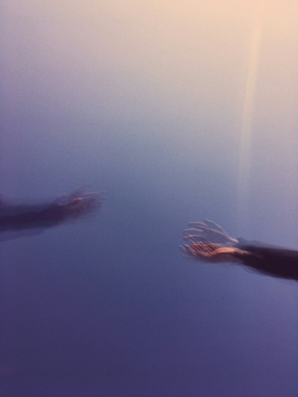 person in black pants under water