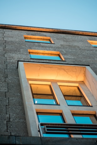 A sleek, modern office building exterior bathed in warm sunlight, symbolizing global contractor partnerships.