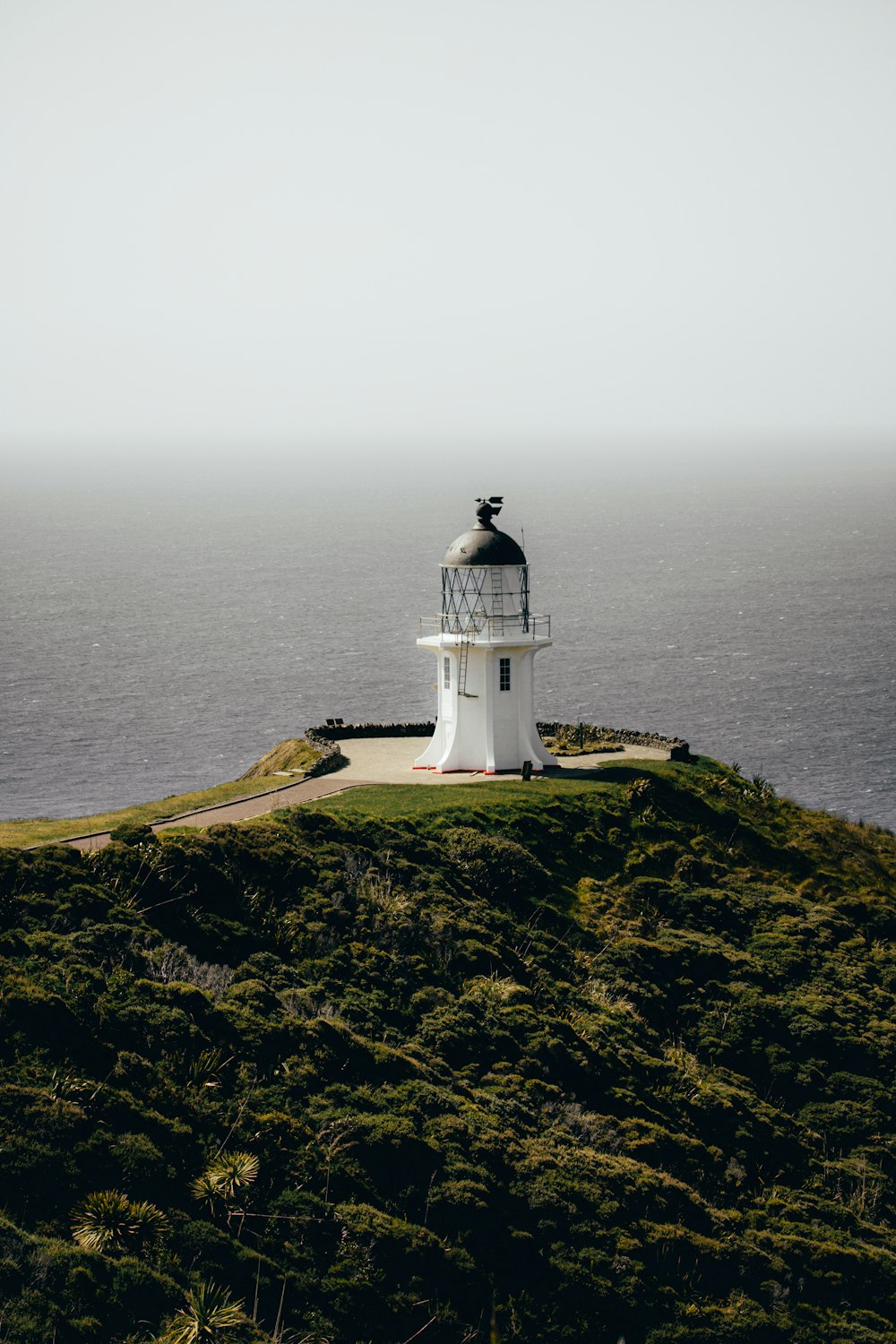 white lighthouse on top of mountain