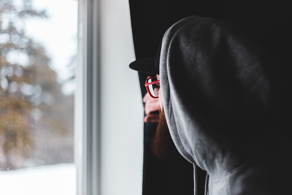 man in black hat and gray hoodie