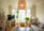 A cozy living room featuring rustic western-style furniture with a man and woman discussing design ideas.
