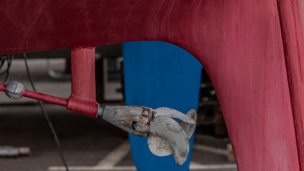 Close-up of a ship's propeller being serviced by skilled technicians.