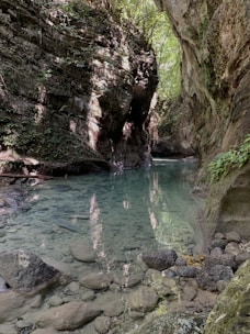 A serene view of a canyon with clear water.