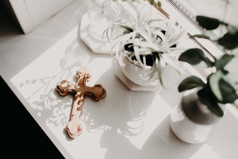 brown wooden cross on white ceramic mug