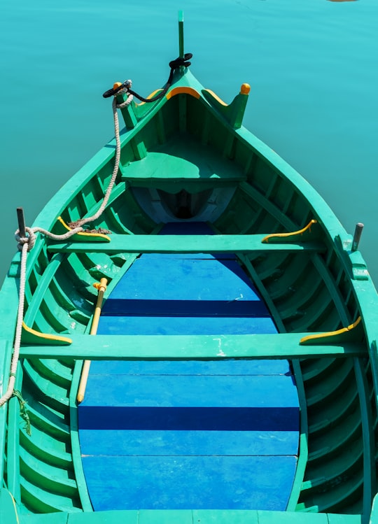 blue and green boat on water in Valletta Malta